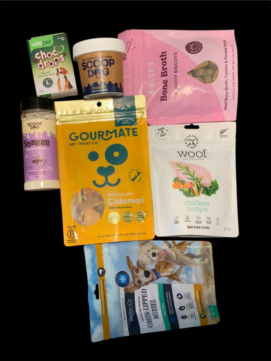 Assorted premium dog treats and snacks from Pawsome Pooch Parcels gift box, New Zealand.