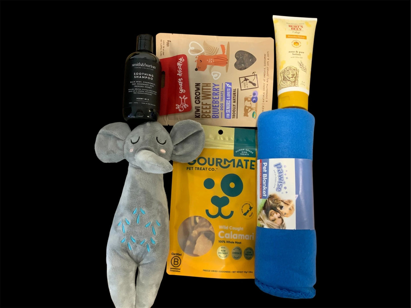 Premium dog gift box with plush elephant toy, treats, shampoo, blanket, and paw lotion