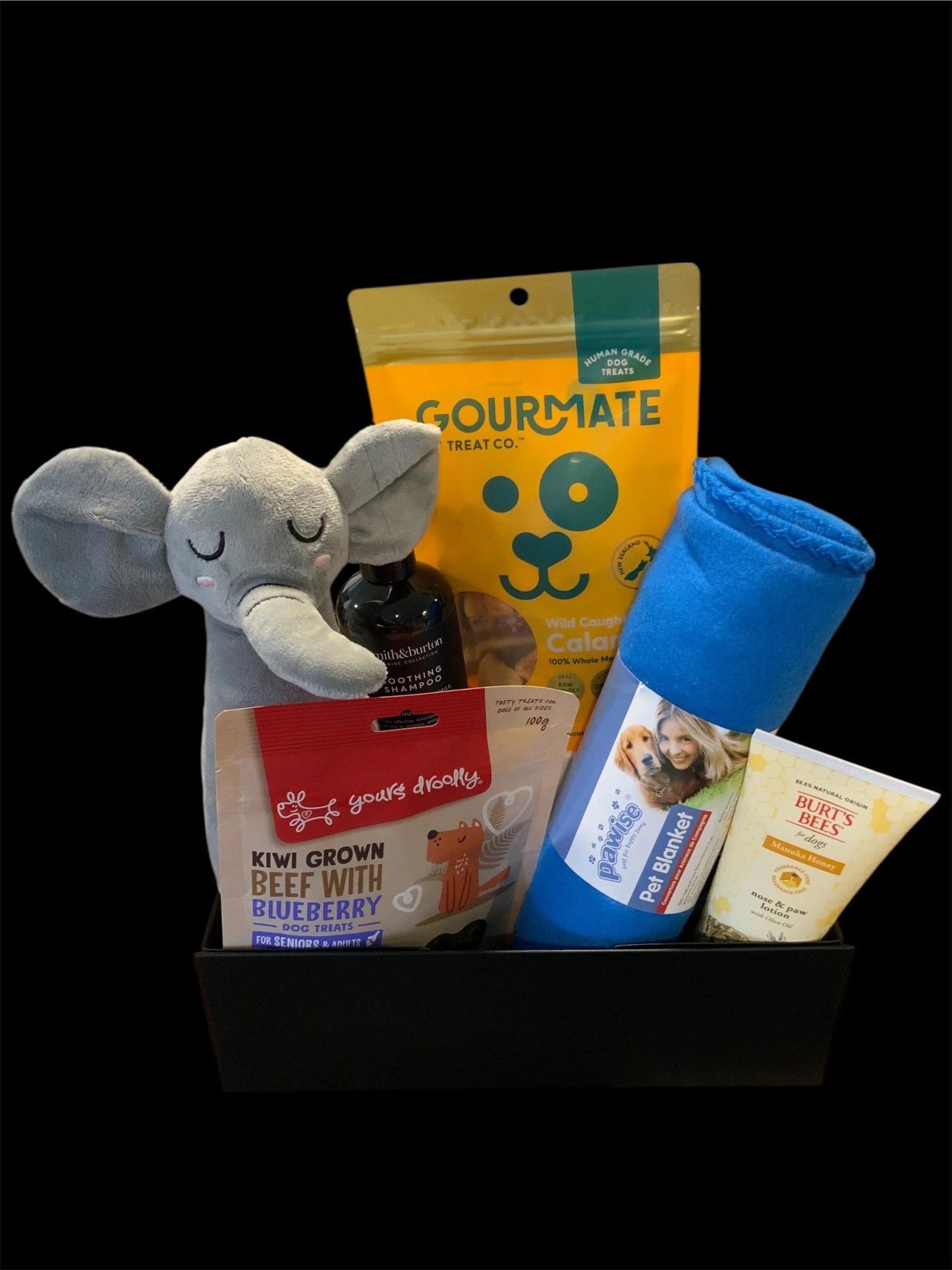 Premium dog gift box with treats, plush toy, pet blanket, shampoo, and balm from Pawsome Pooch Parcels